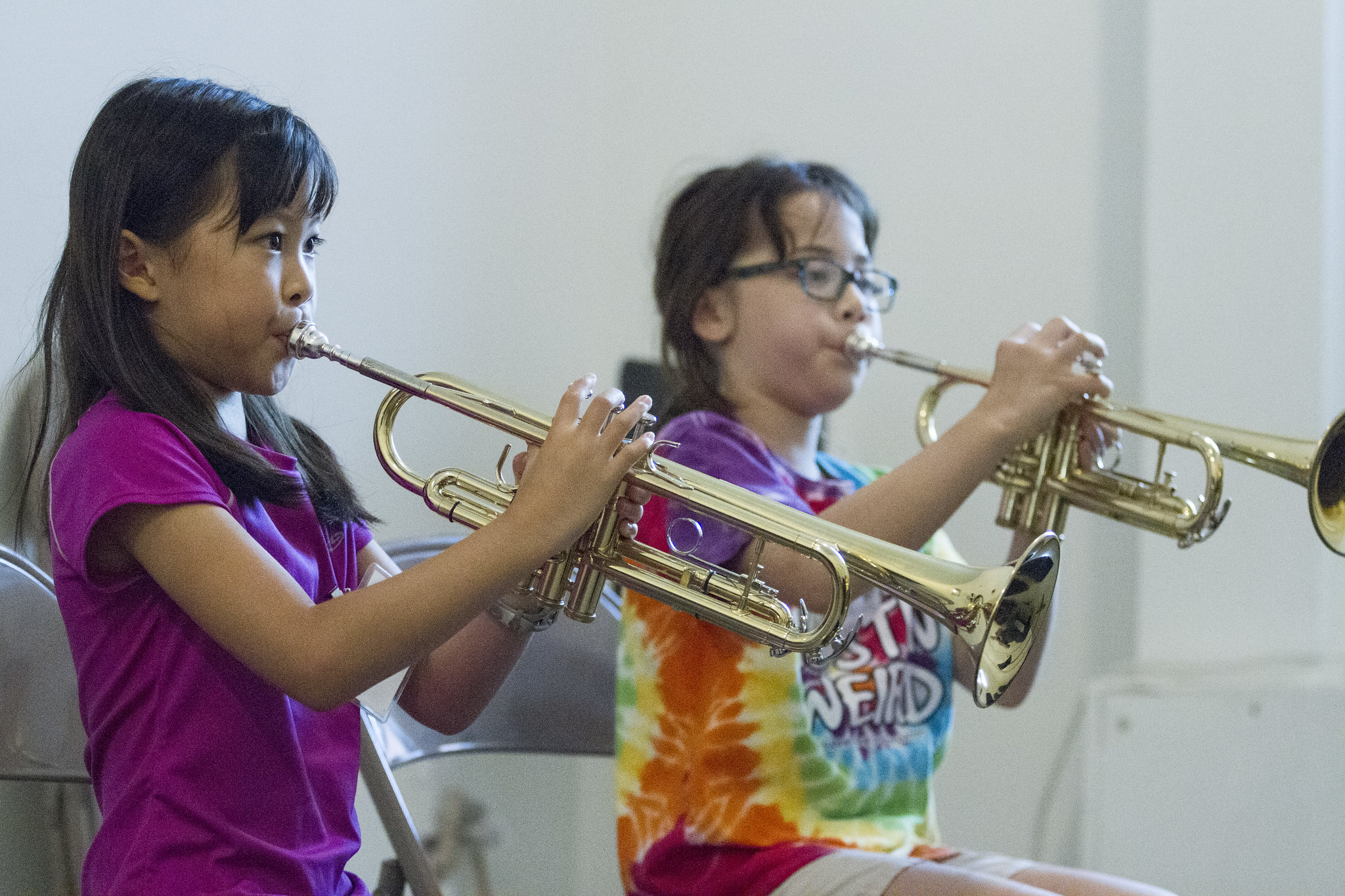 Two girls playing trumpet