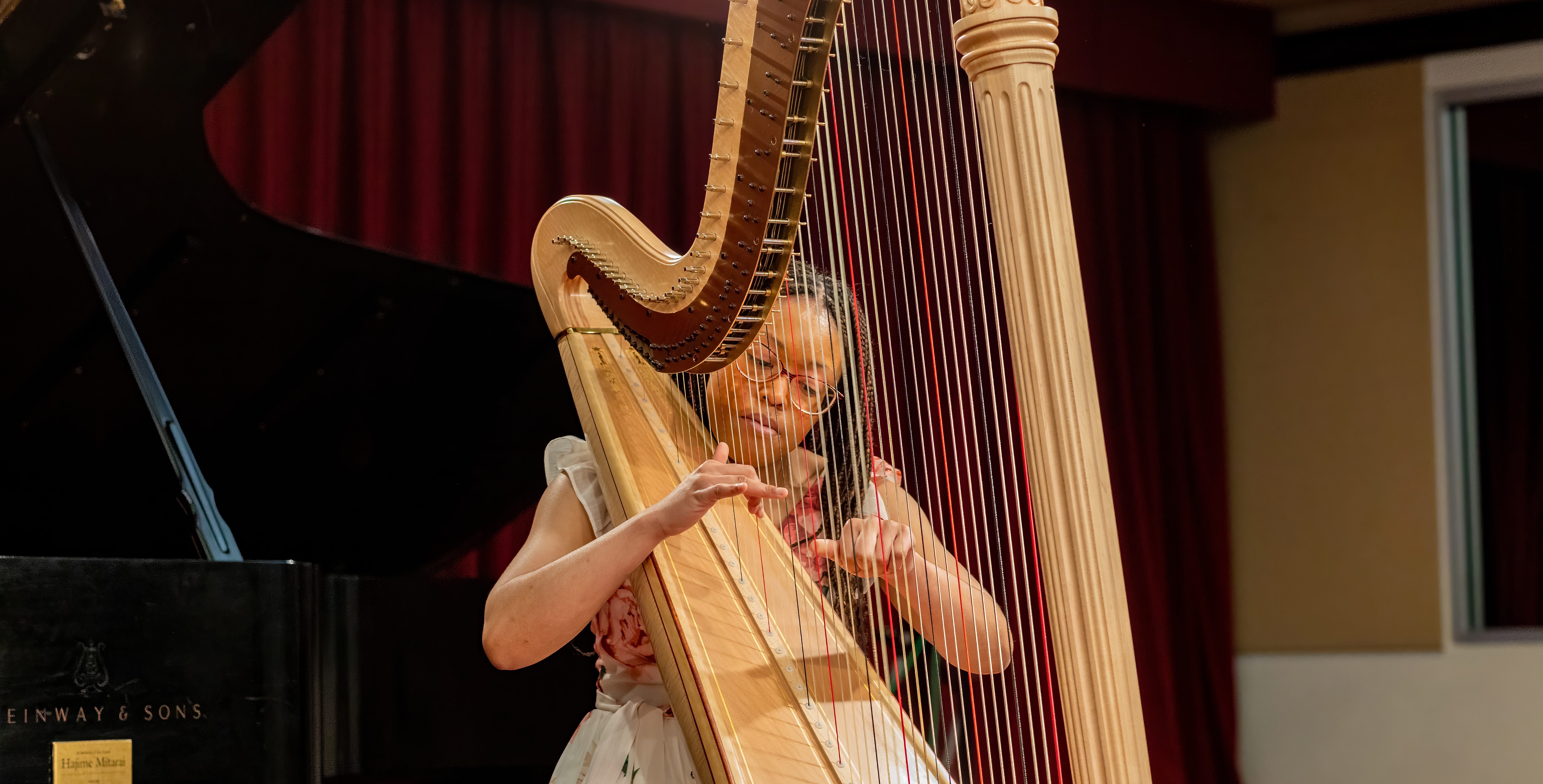 A harpist at the WMPI Graduation Recital