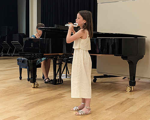 Student playing flute in a recital.