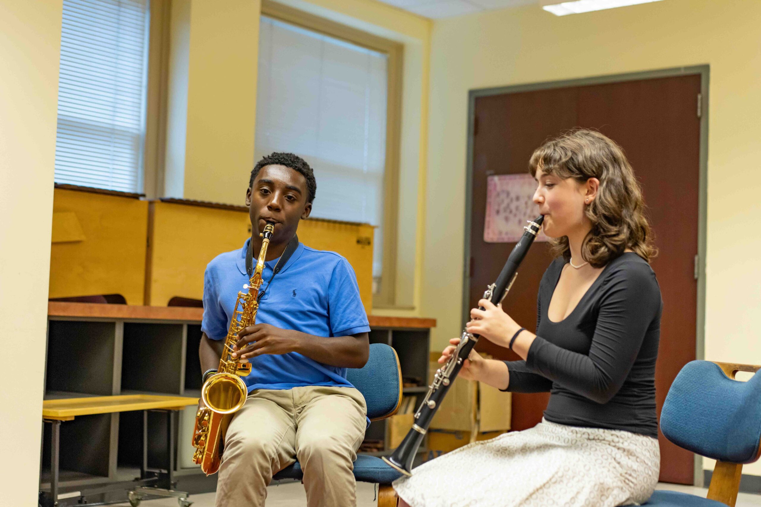 A clarinet and sax student rehearsing a duet.