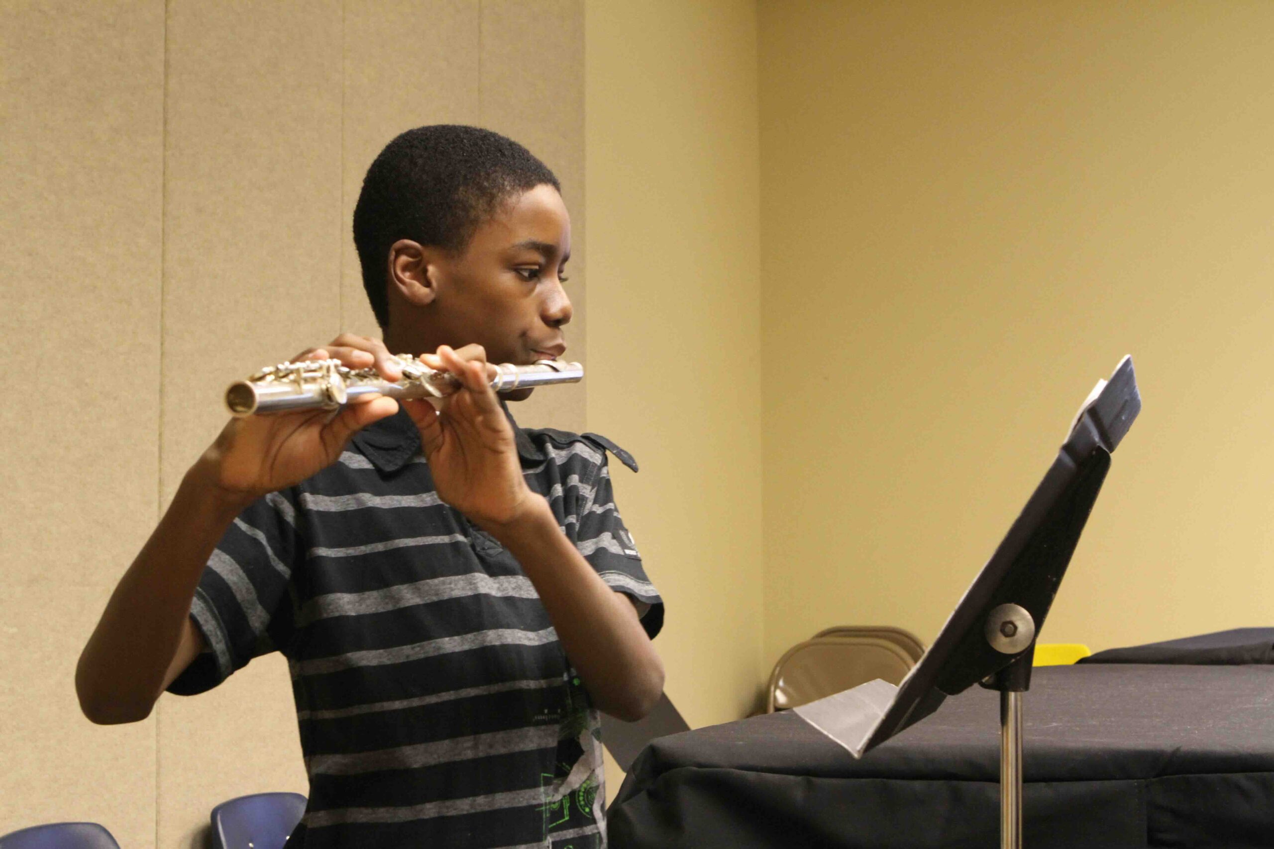 A flute student practicing for his lesson.