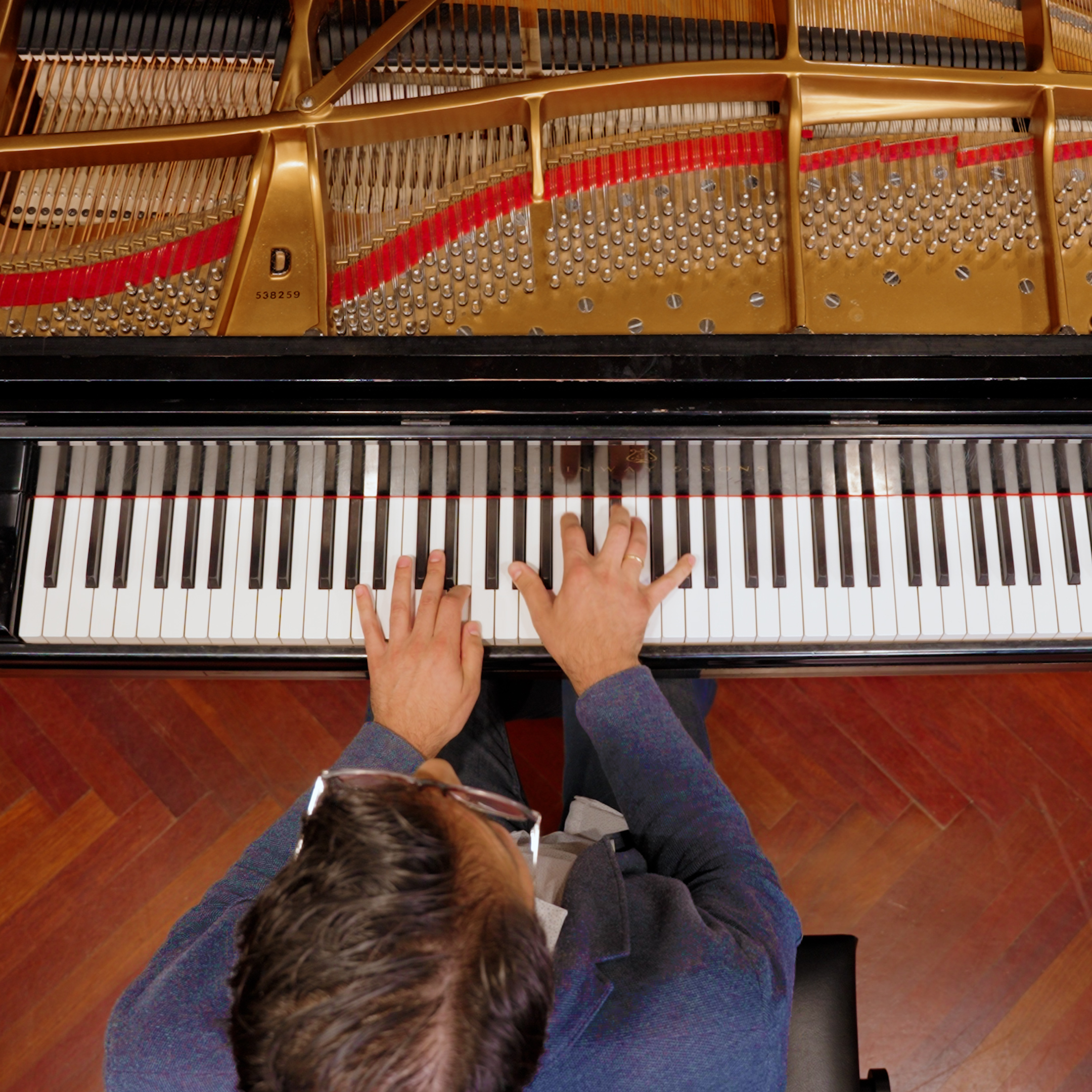 A Levine faculty member playing piano, taken from above.