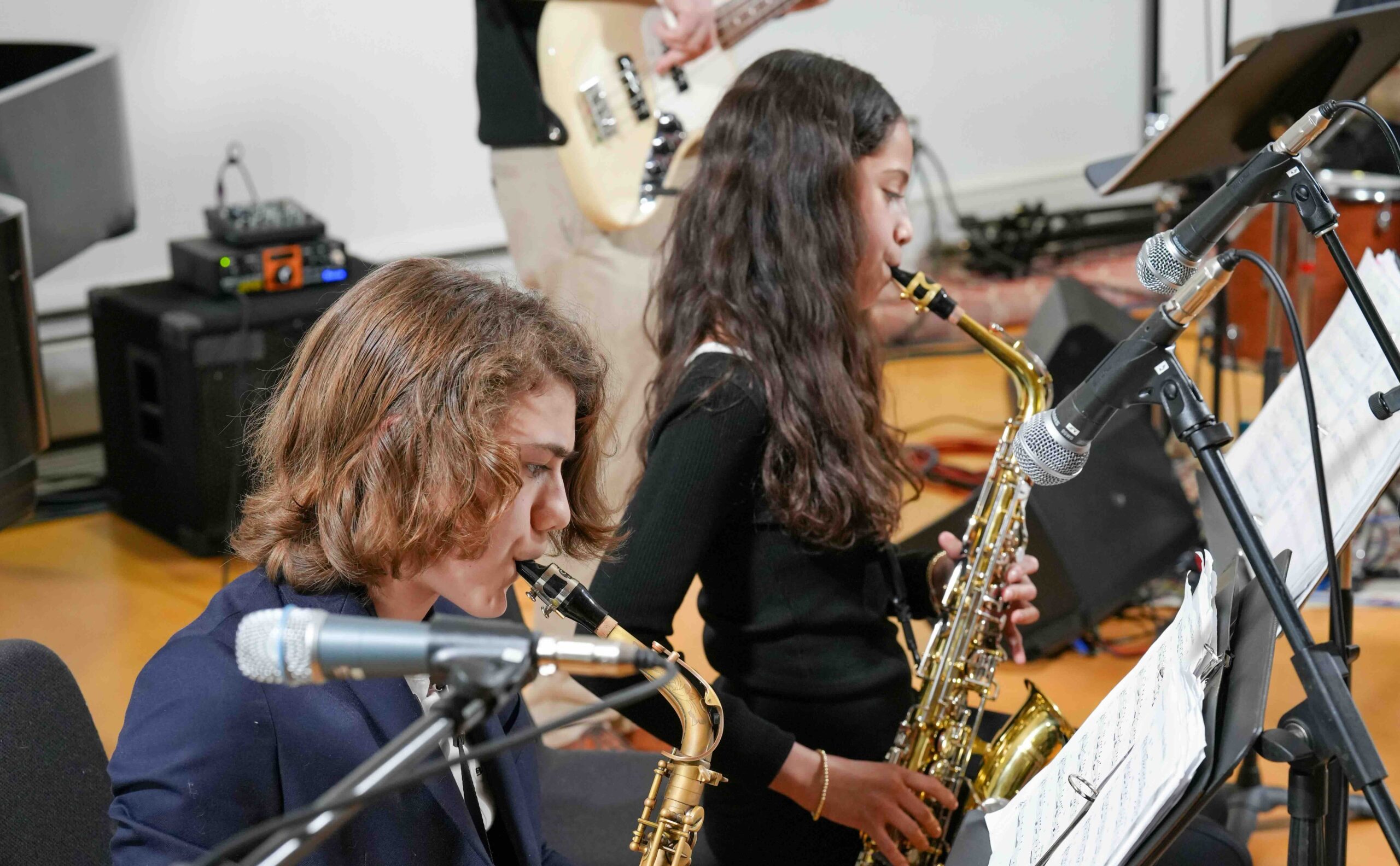 Two sax players in a jazz ensemble.