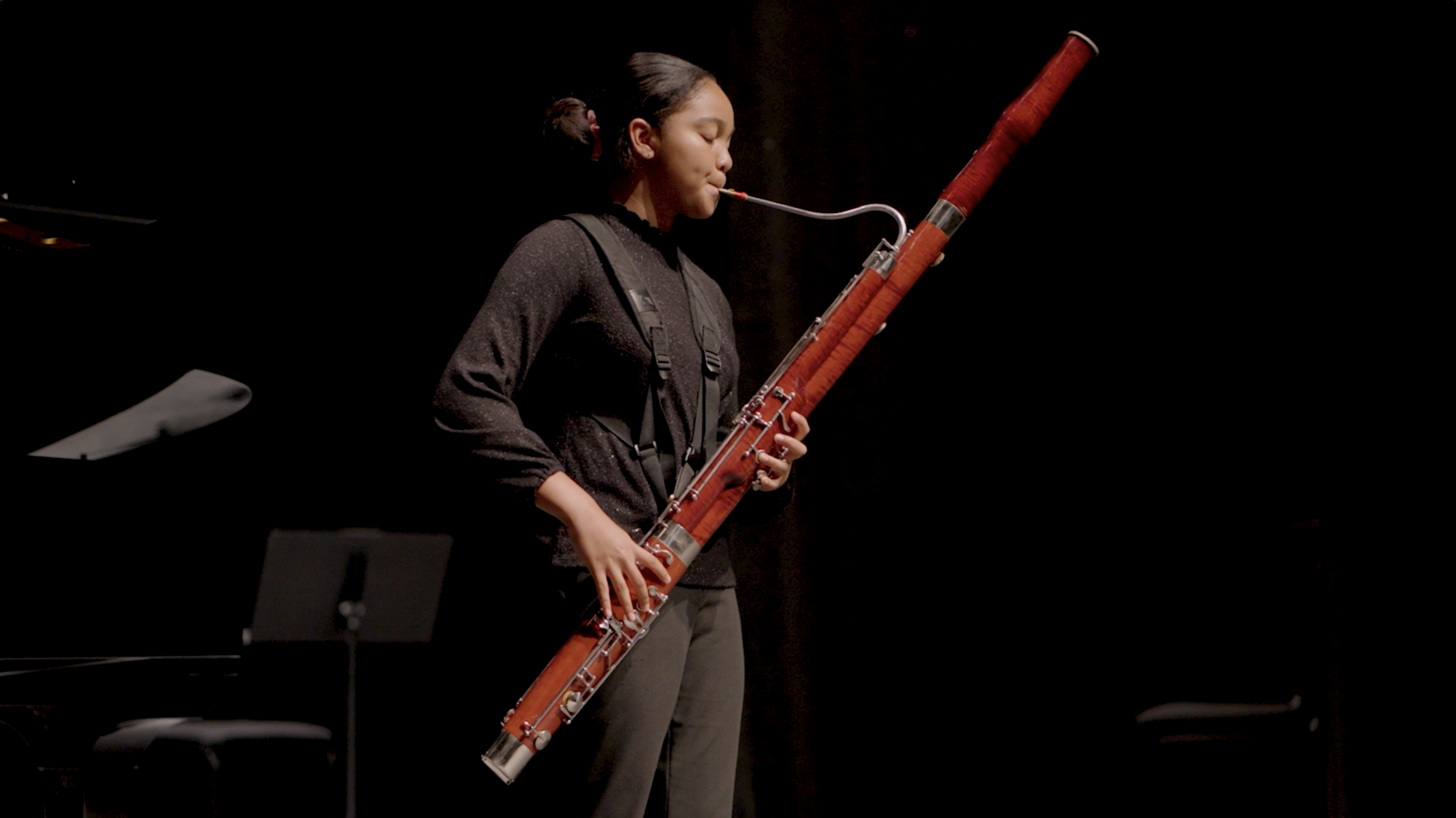 A bassoonist performing in a recital.