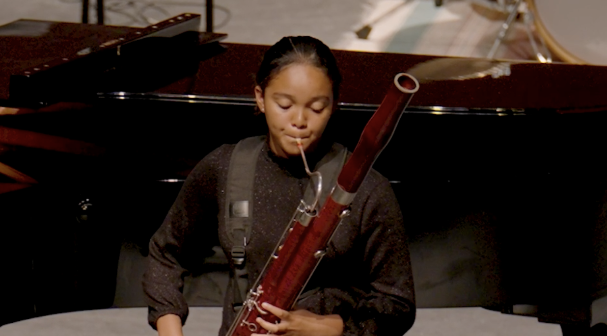 A bassoonist performing in a recital.