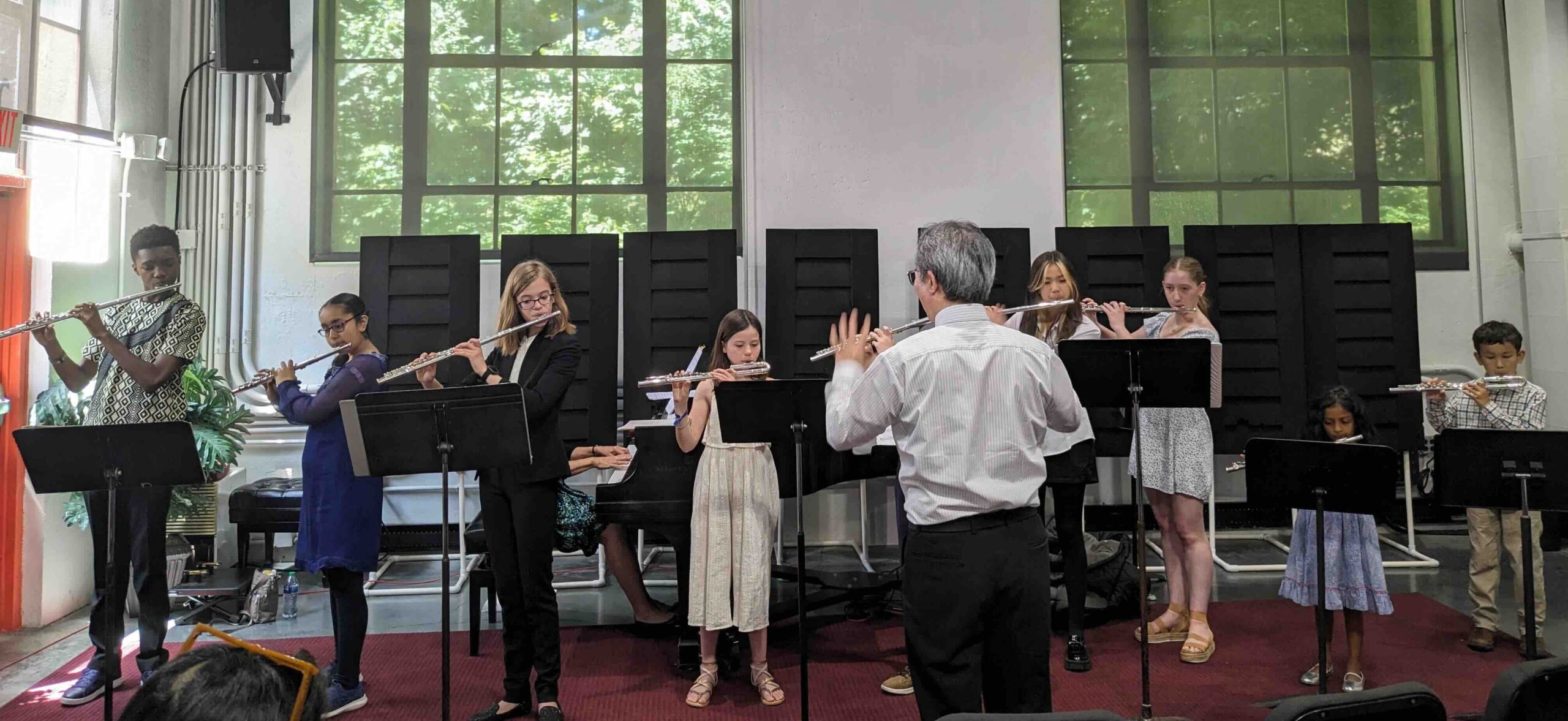 A group of Suzuki flute students performing in a recital.