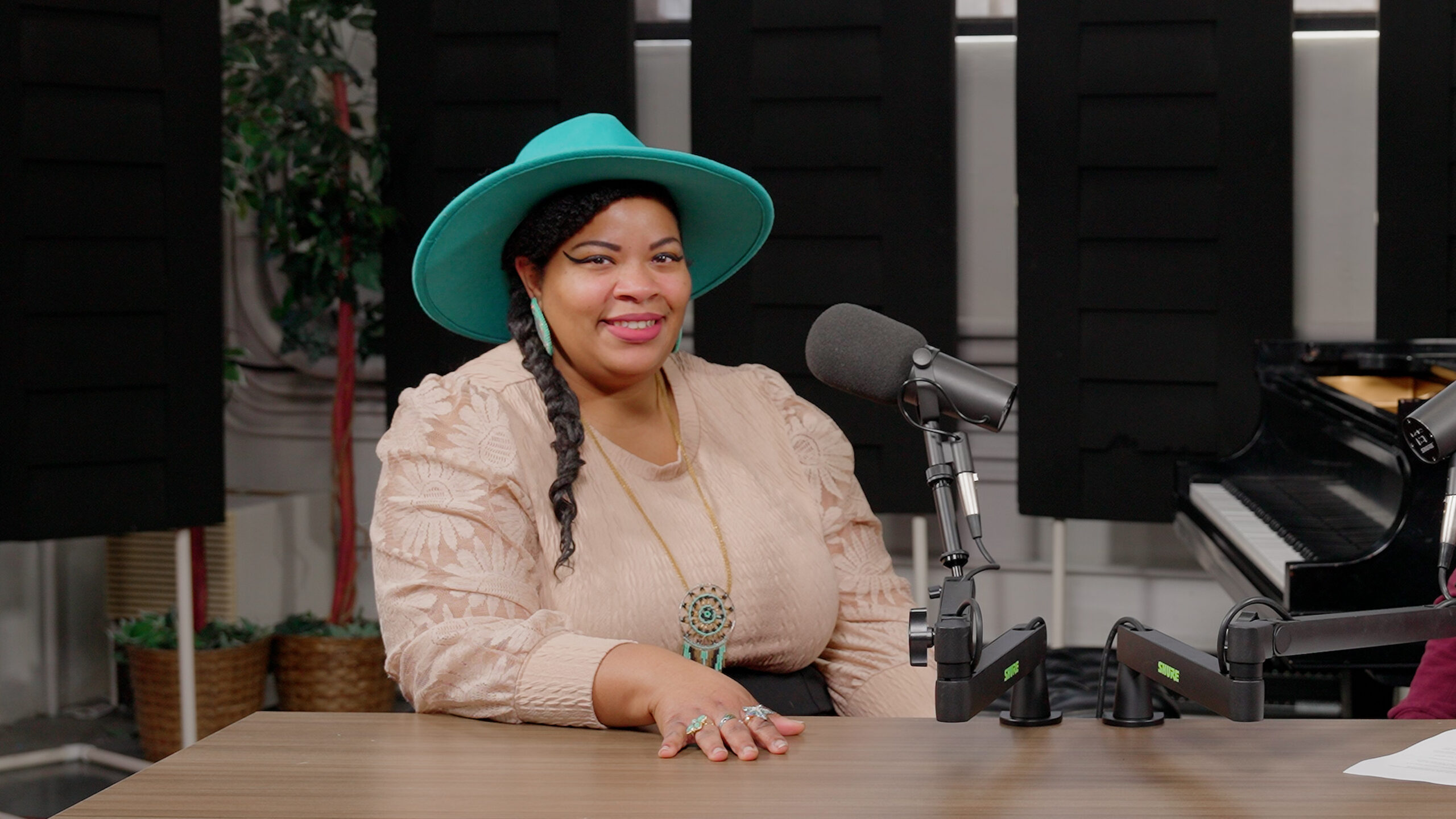 Carly Harvey sitting at table with a microphone.