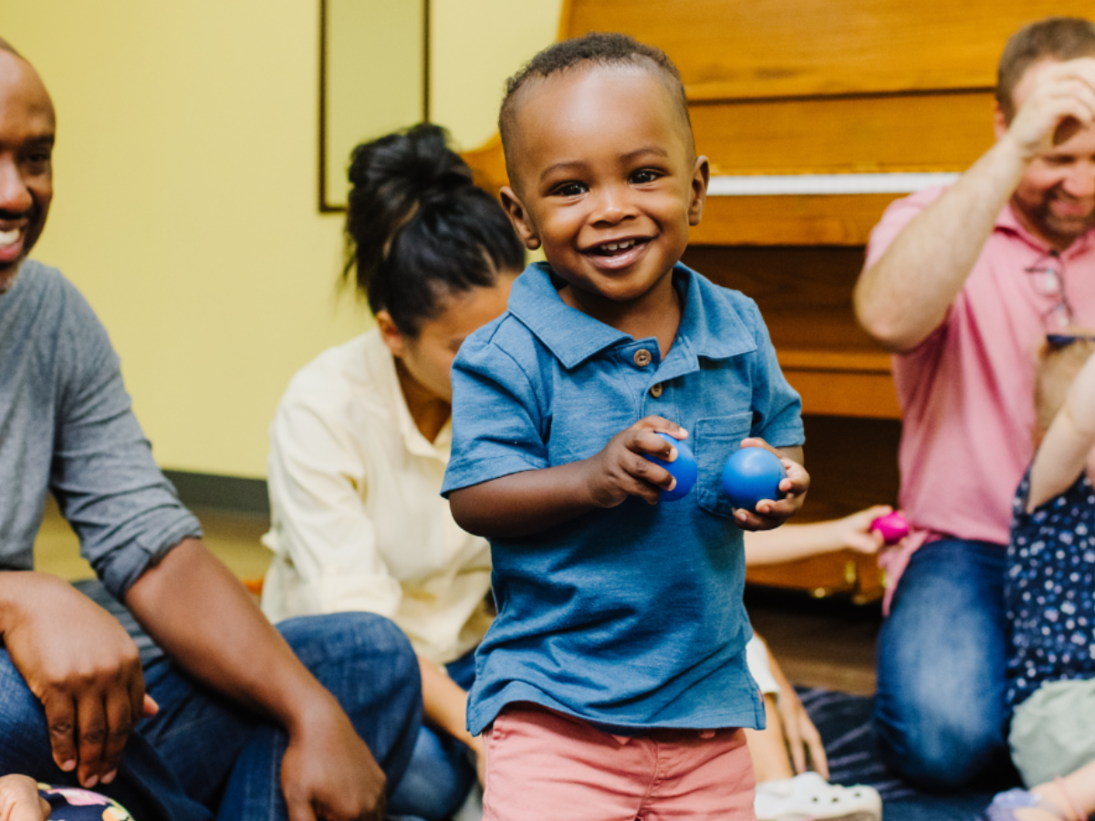 Young boy enjoying a First Music class.
