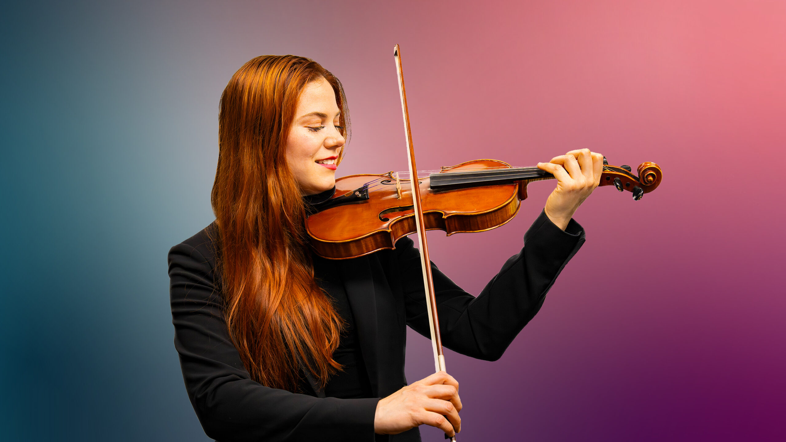 Photo of Holly Nelson holding a violin.