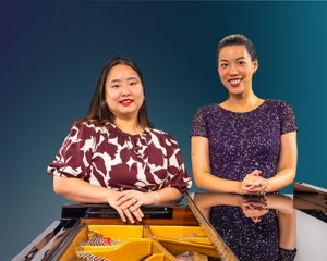Image of Minji Kim and Rachel Chen standing in behind a grand piano.