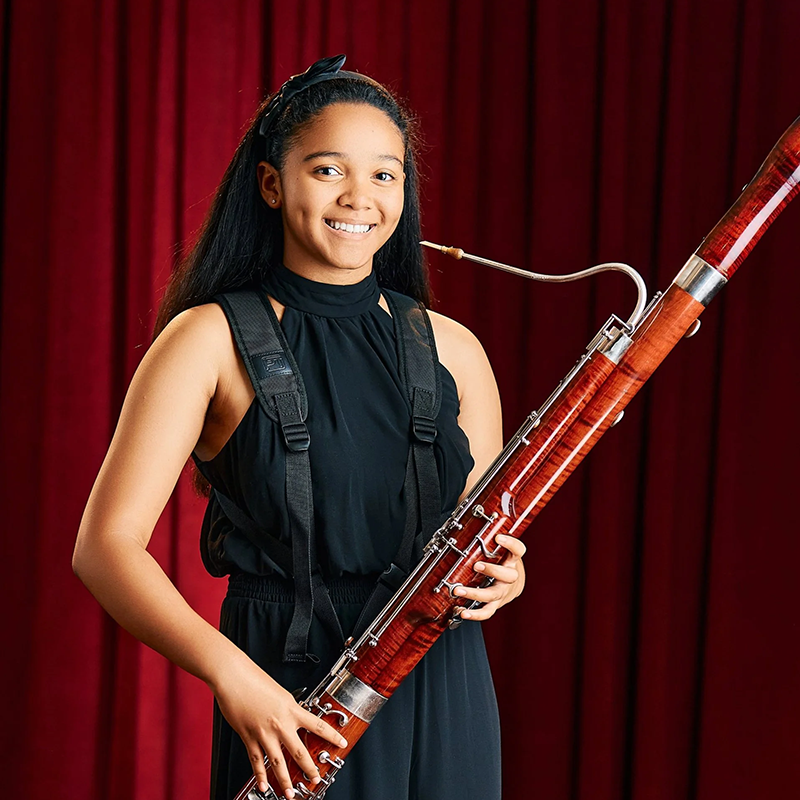 Photo of Chloe Robertson holding a bassoon.