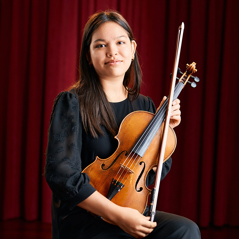 Photo of Jane Morrison holding a violin.