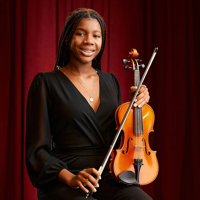 Photo of Victoria Hightower holding a violin.